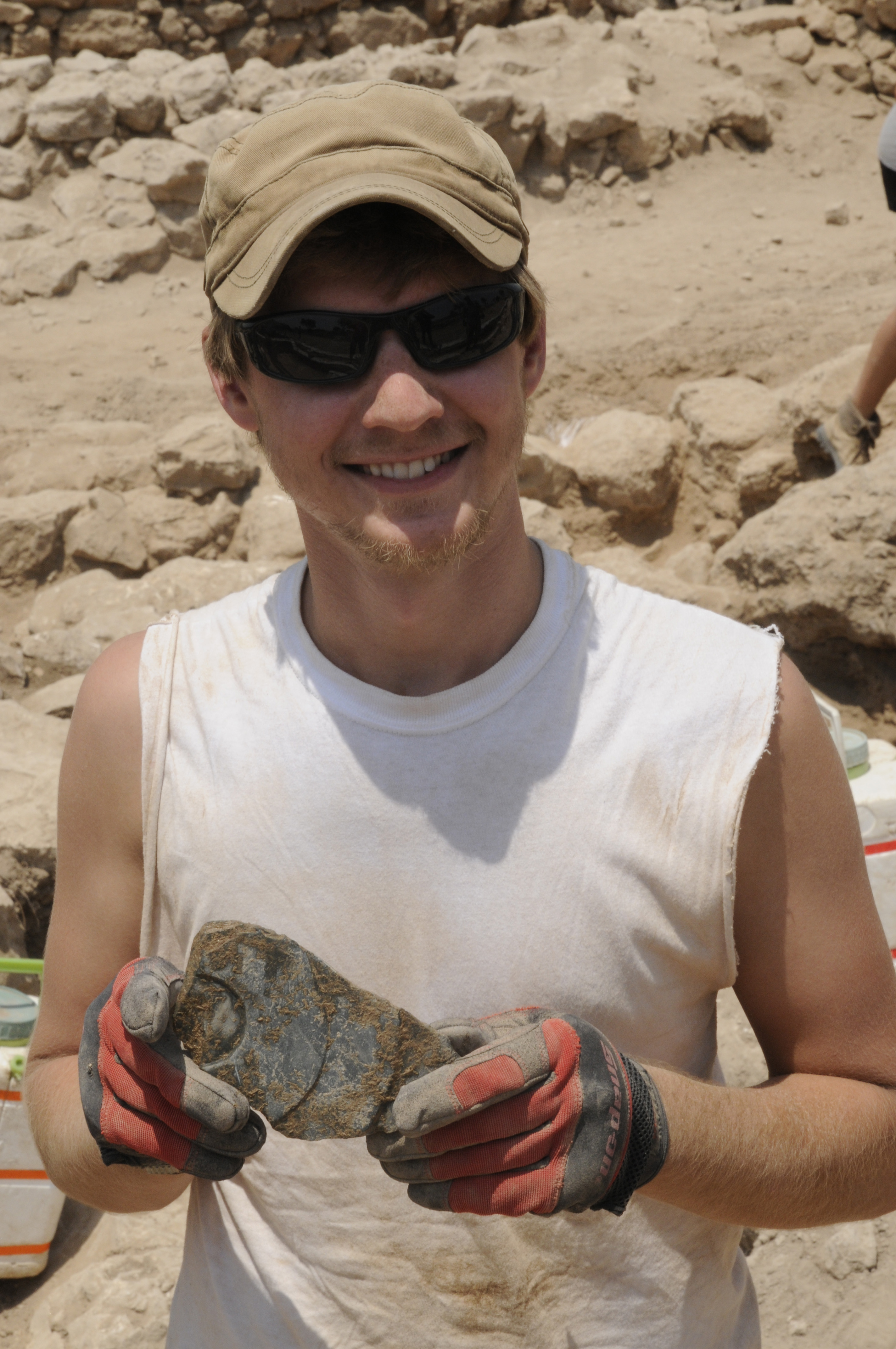 Volunteer holding a pot sherd 