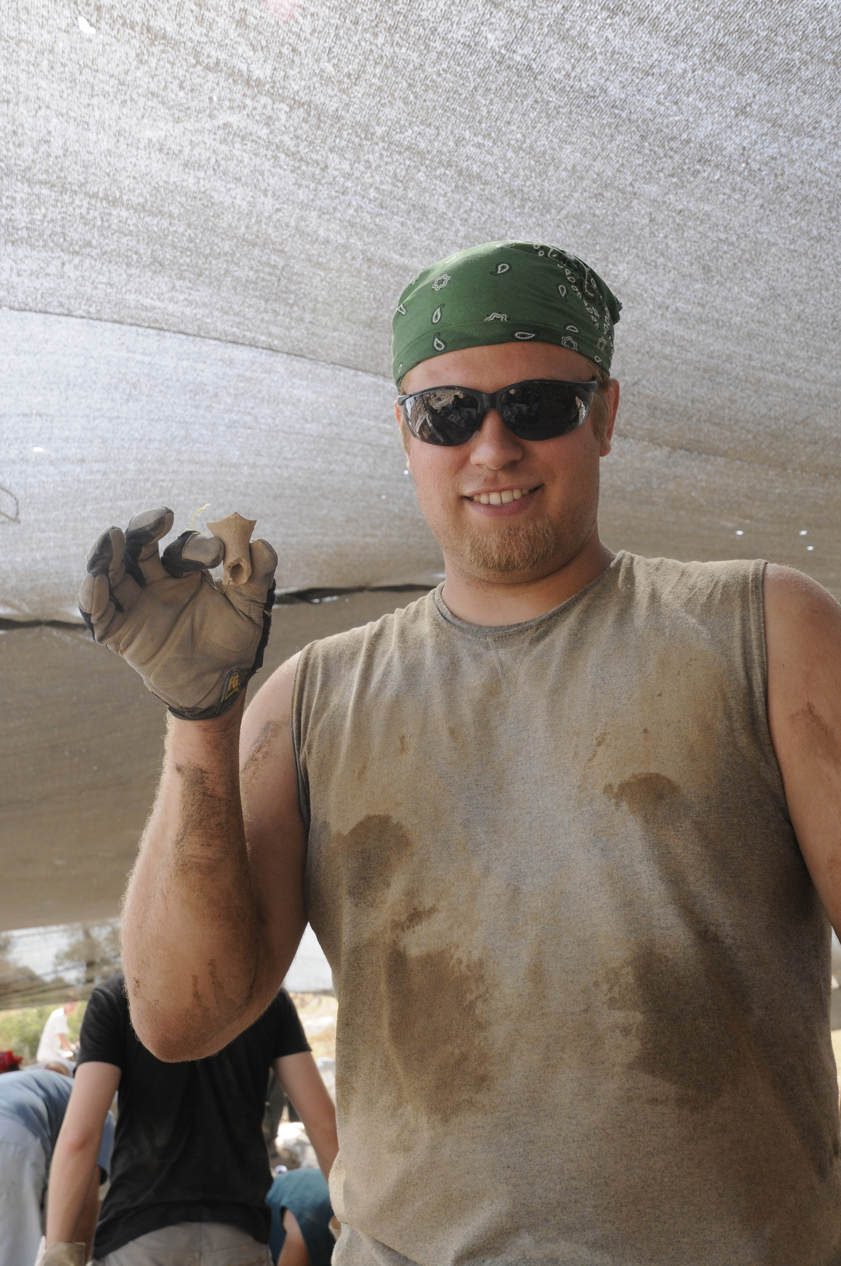 Volunteer holding a pot sherd 