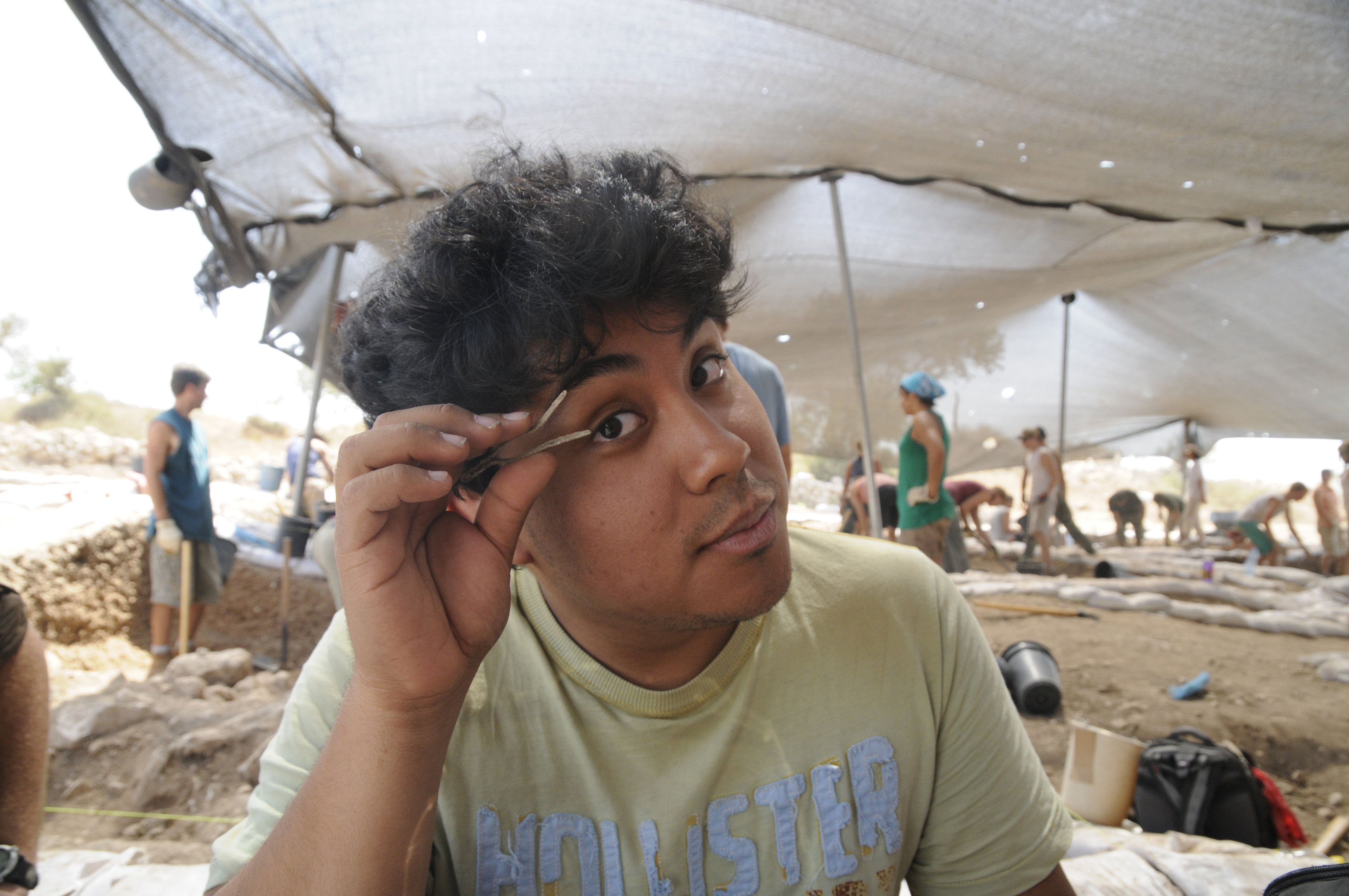 Volunteer holding an artifact