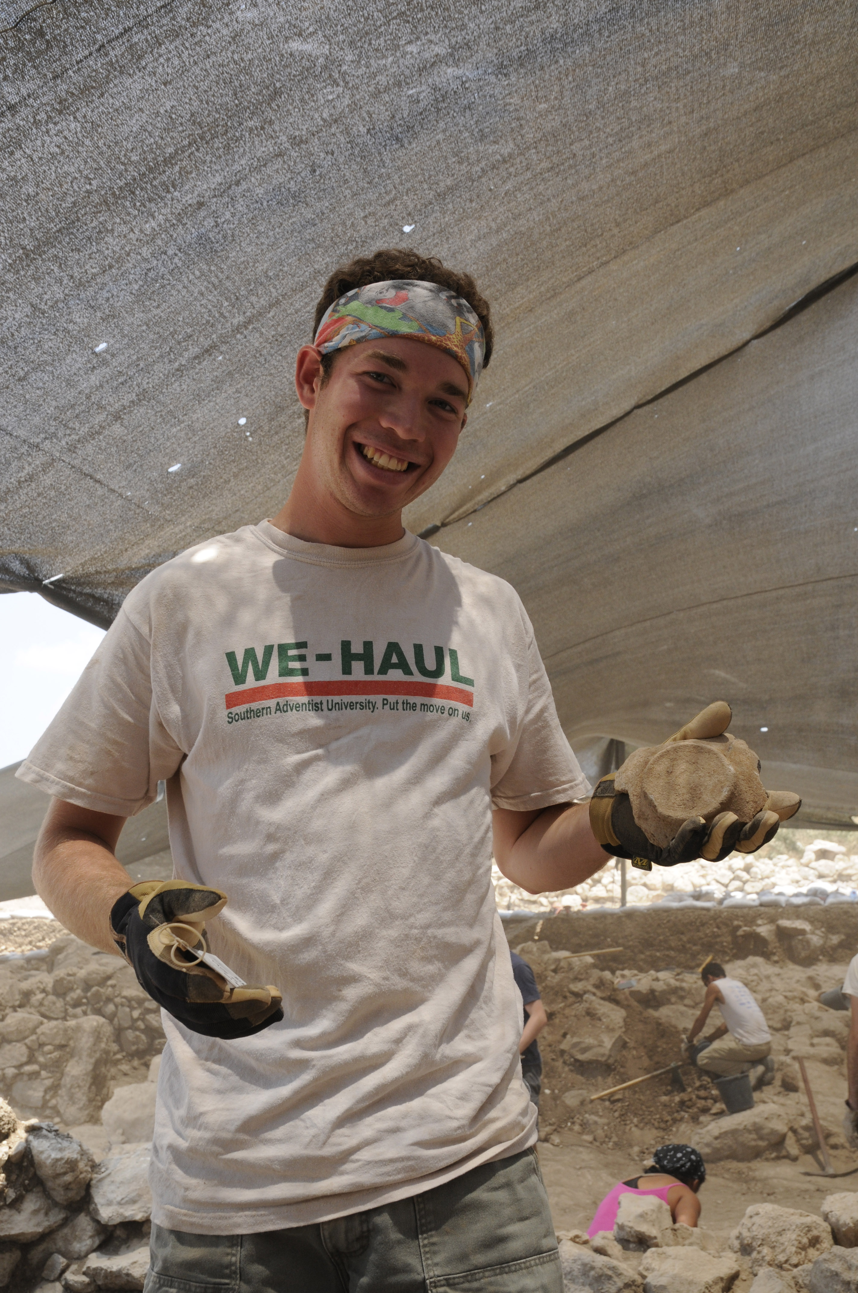 Volunteer holding a artifact