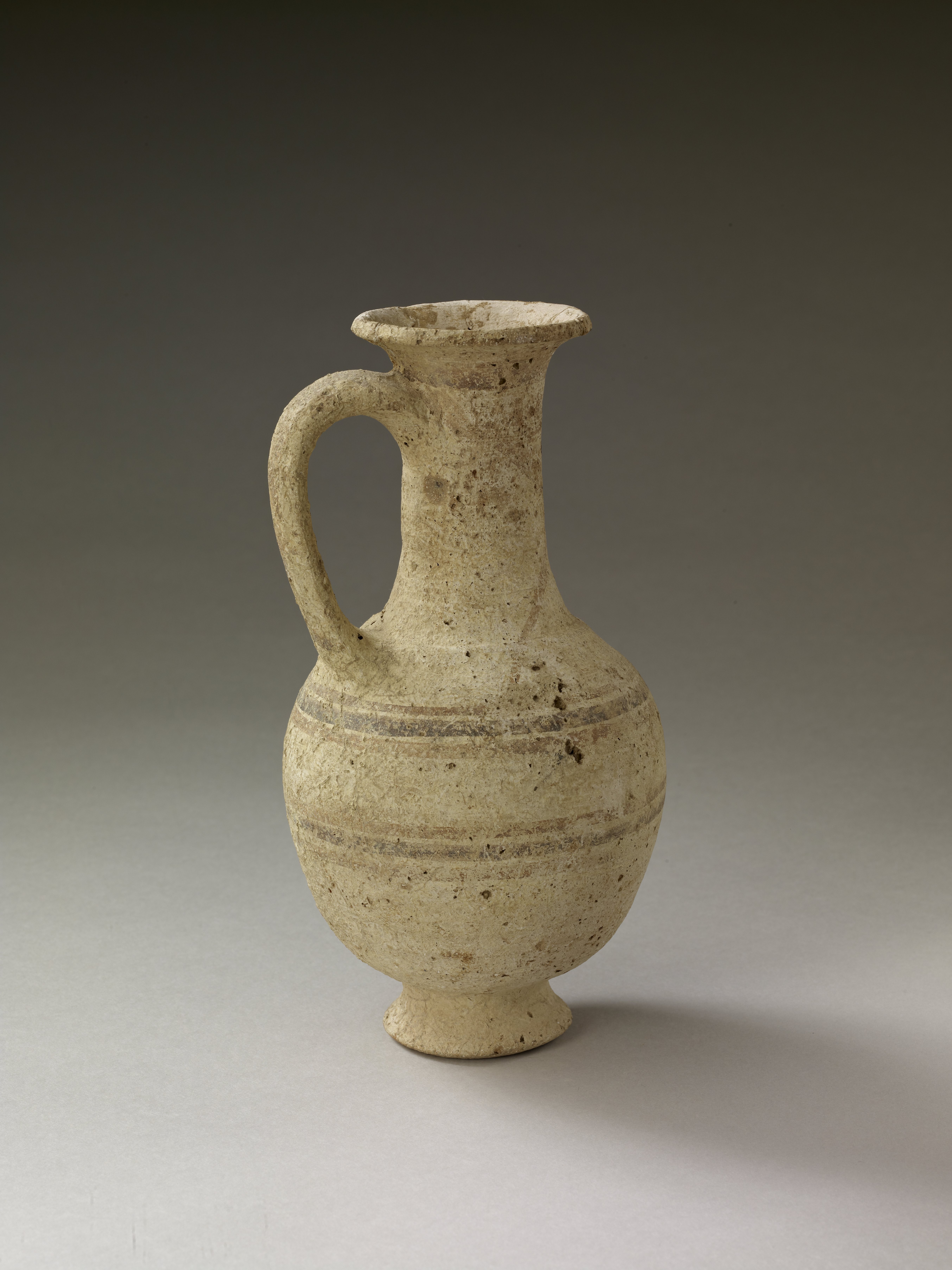 An example of Mycenaean pottery; a jug with a long neck and red and black slip.