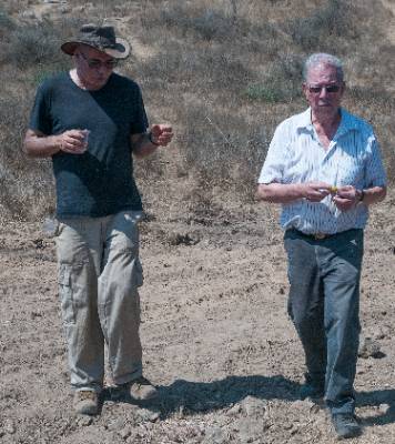 two people walking in a field