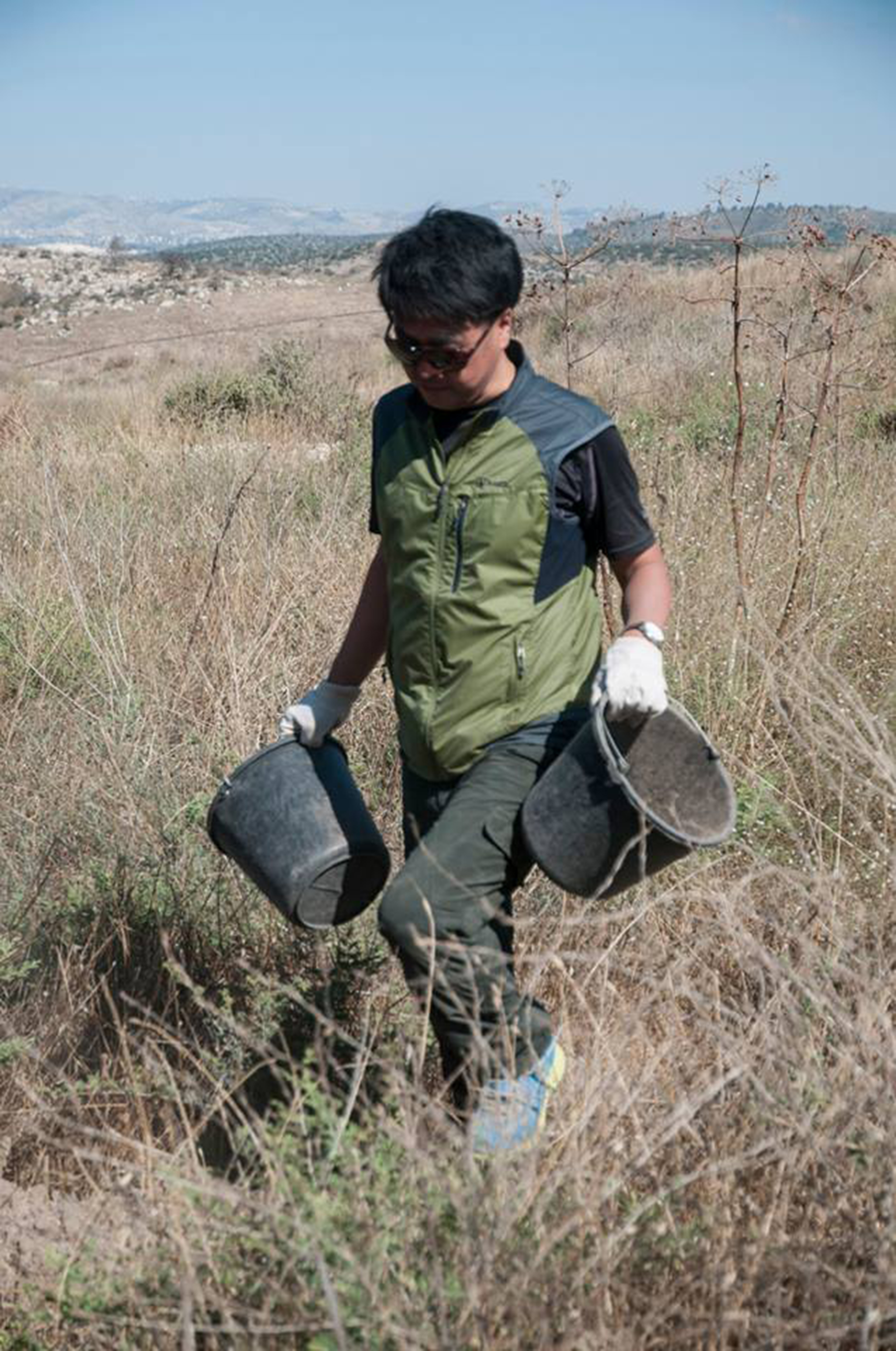 someone carrying buckets