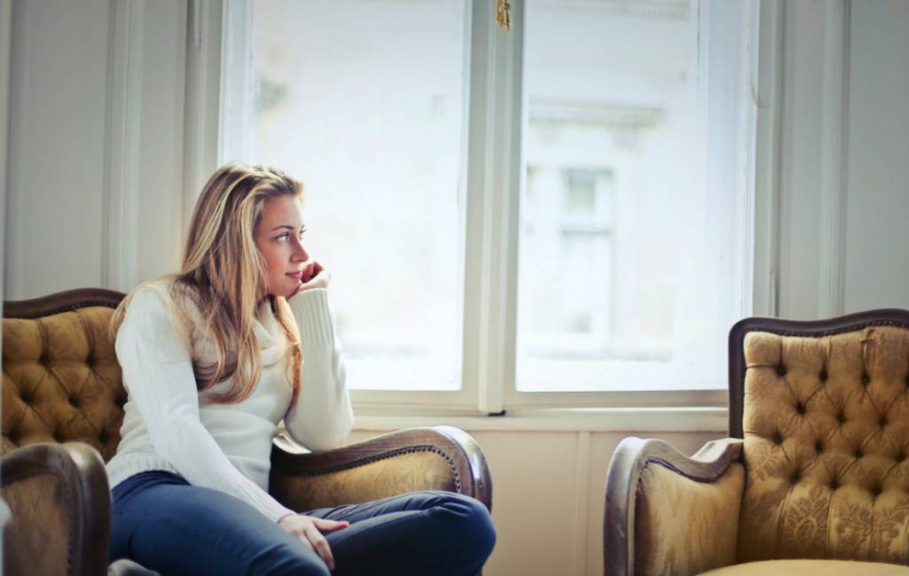 young woman looking out of window