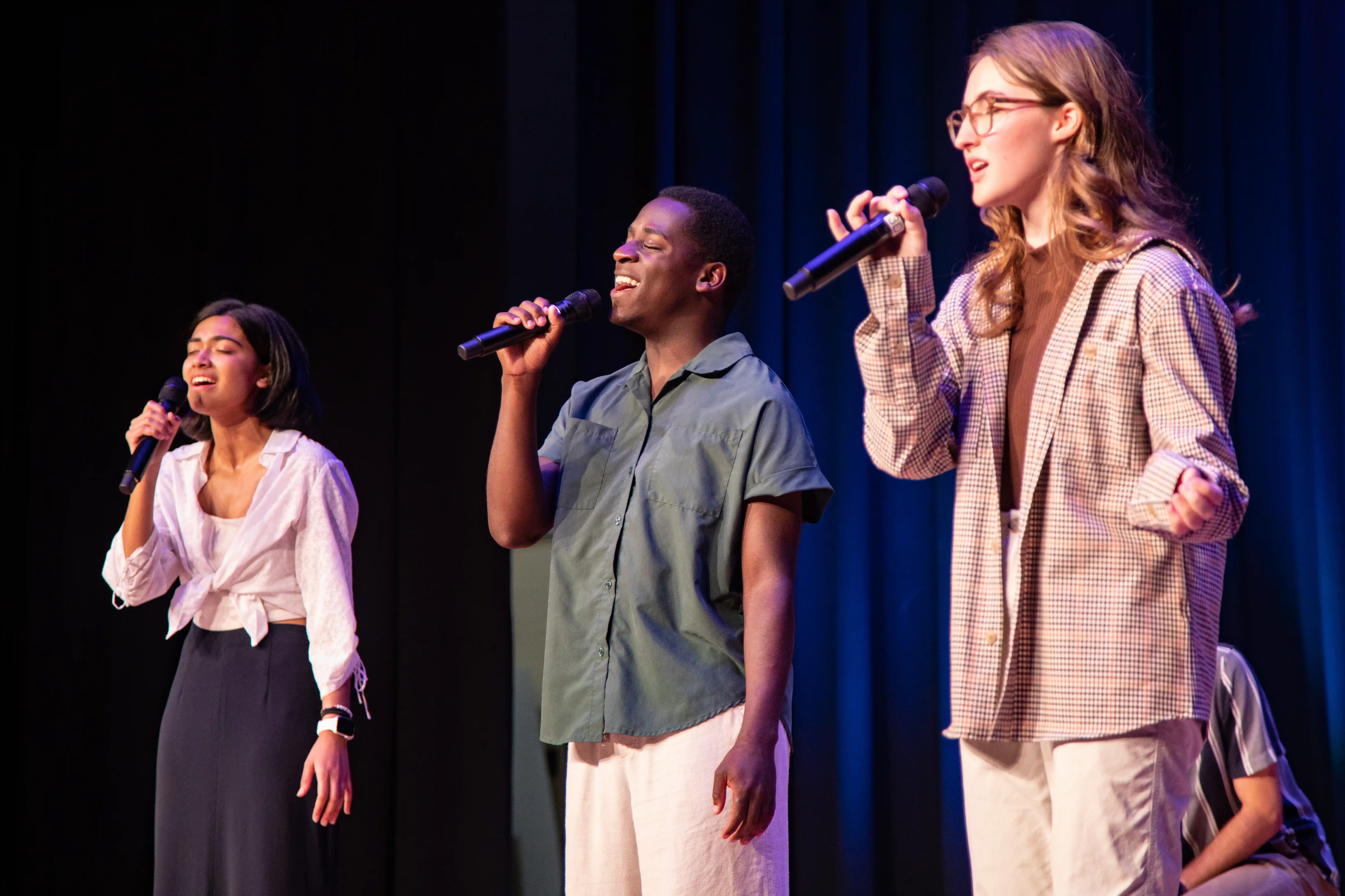 Three students singing christian music