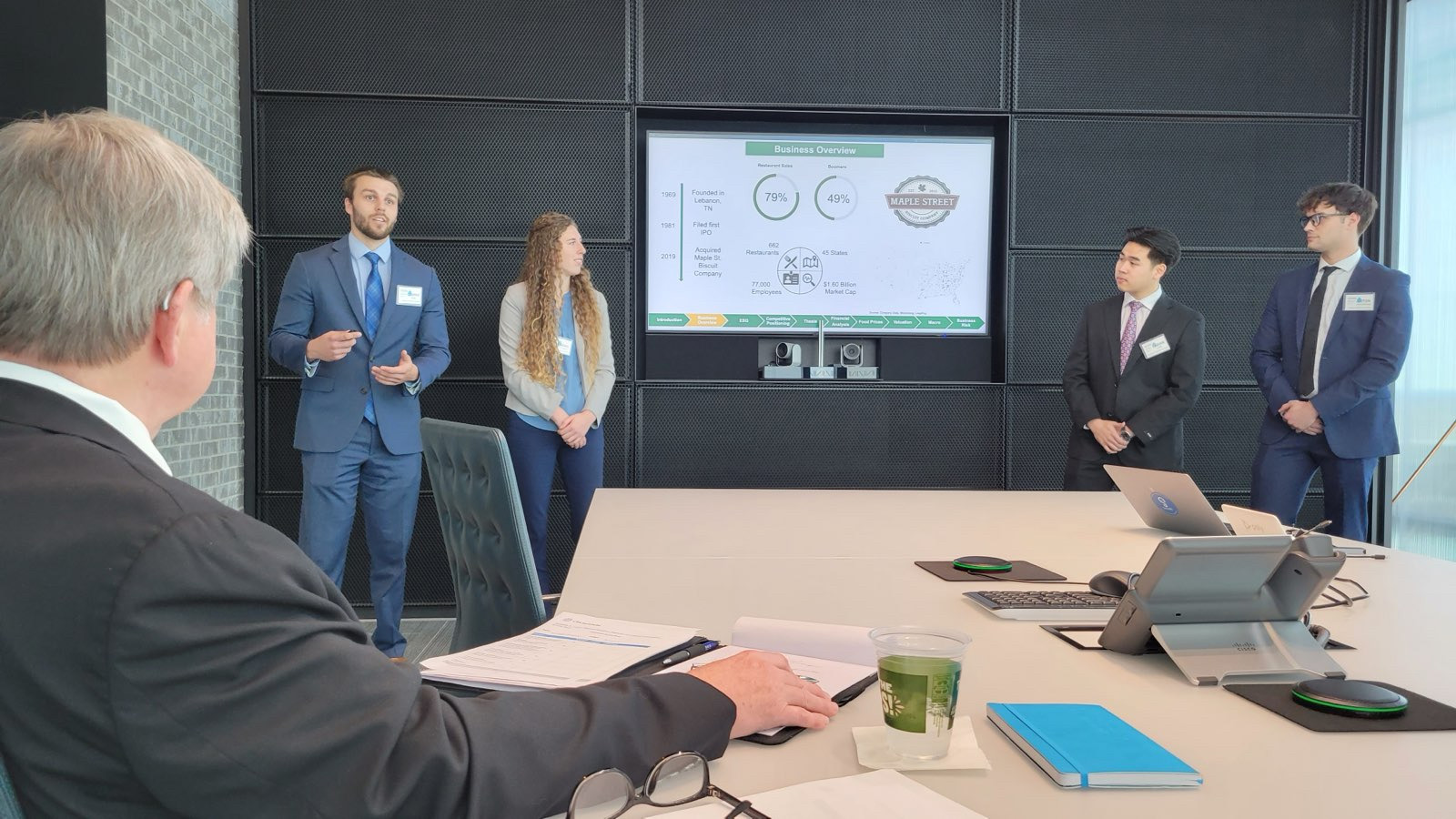 students presenting in a conference room