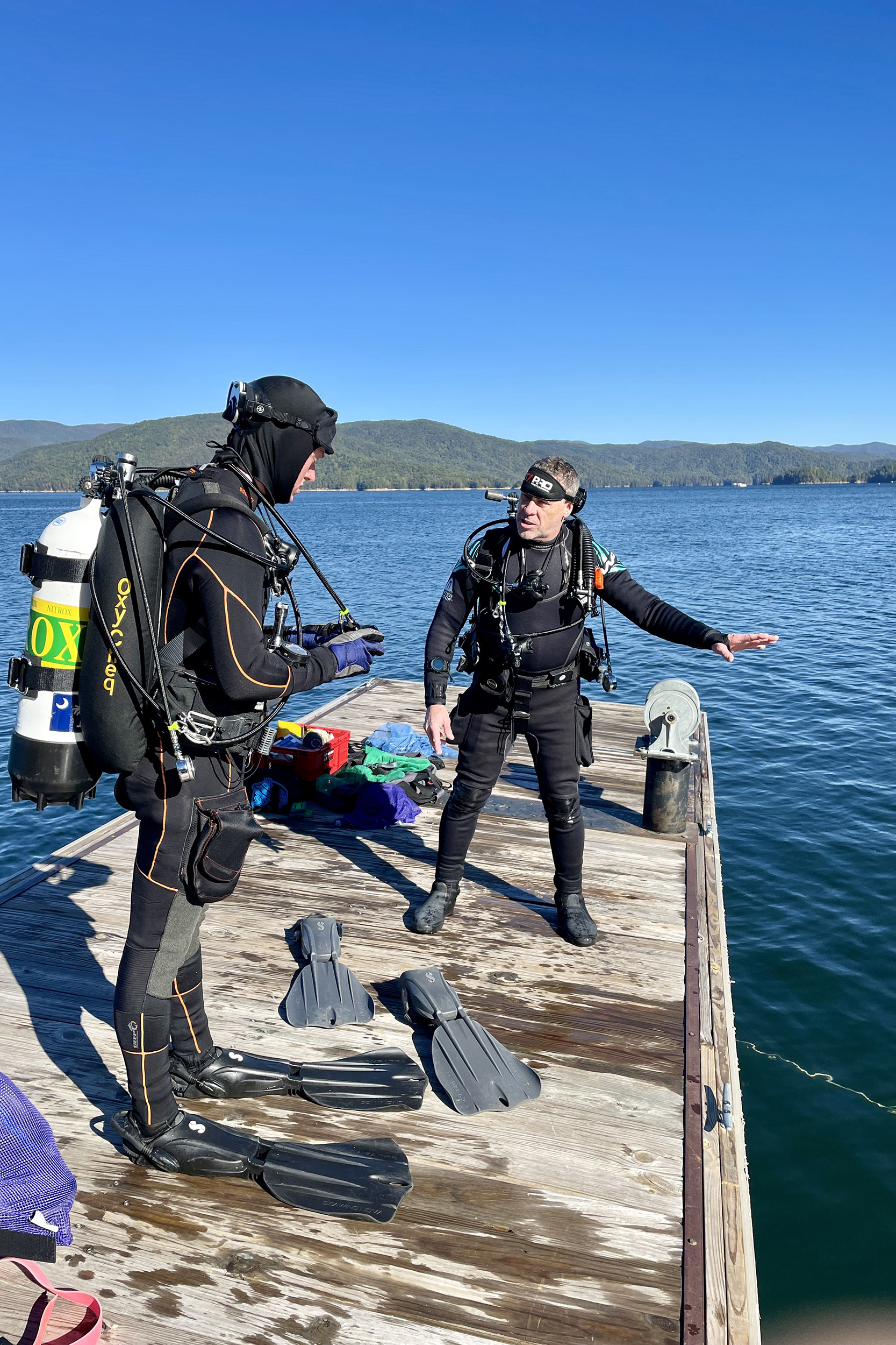 Bo Smith instructs a student as they prepare for a dive.