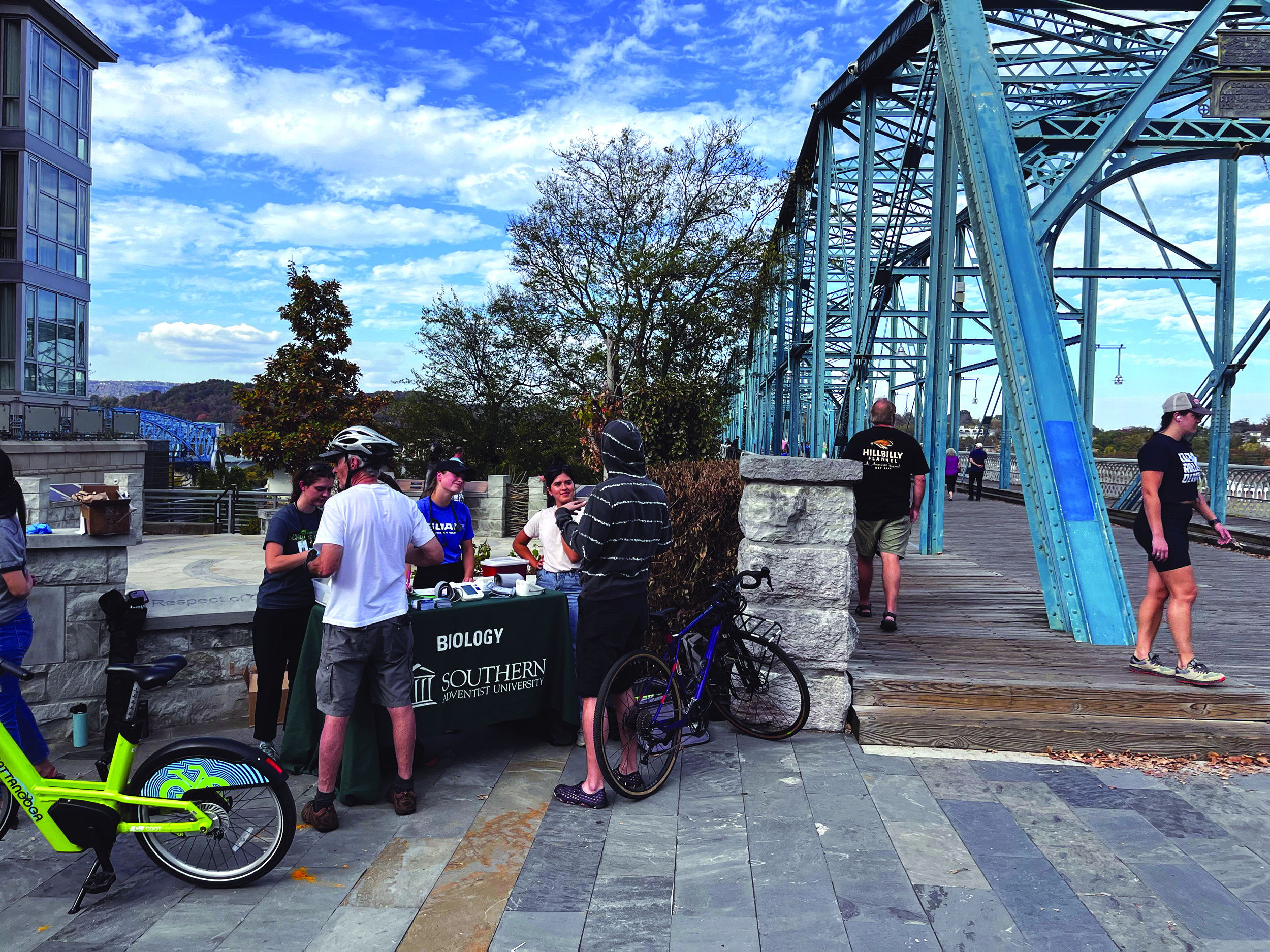 Students talking with community members at a booth in Downtown Chattanooga.