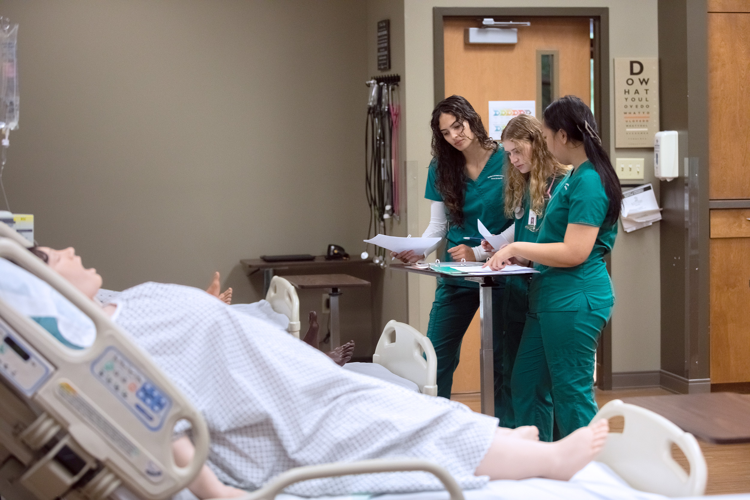 A group of students prepare to practice their skills on the new R42 Bariatric Manikin at Southern Adventist University