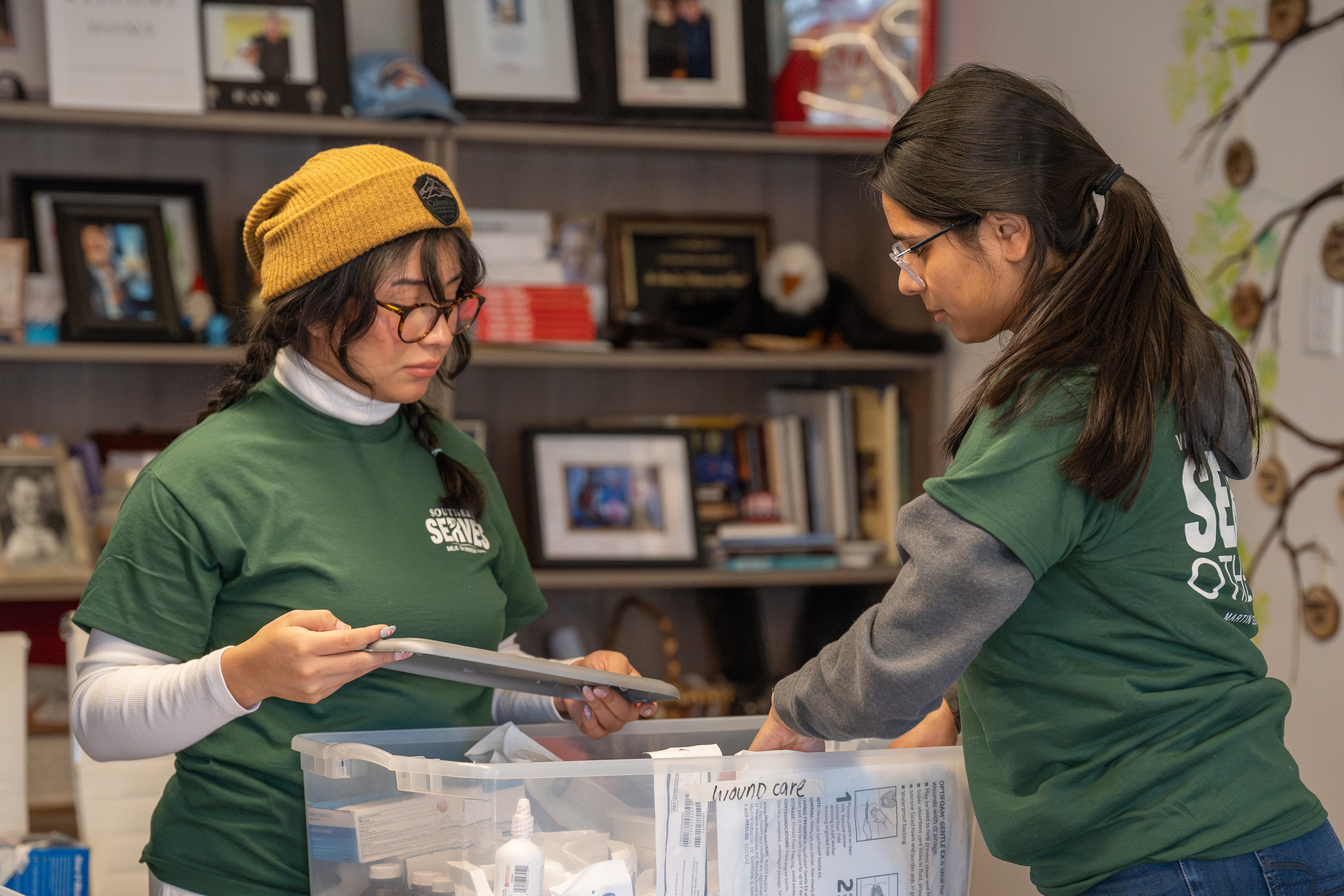 2 students help sort and organize supplies