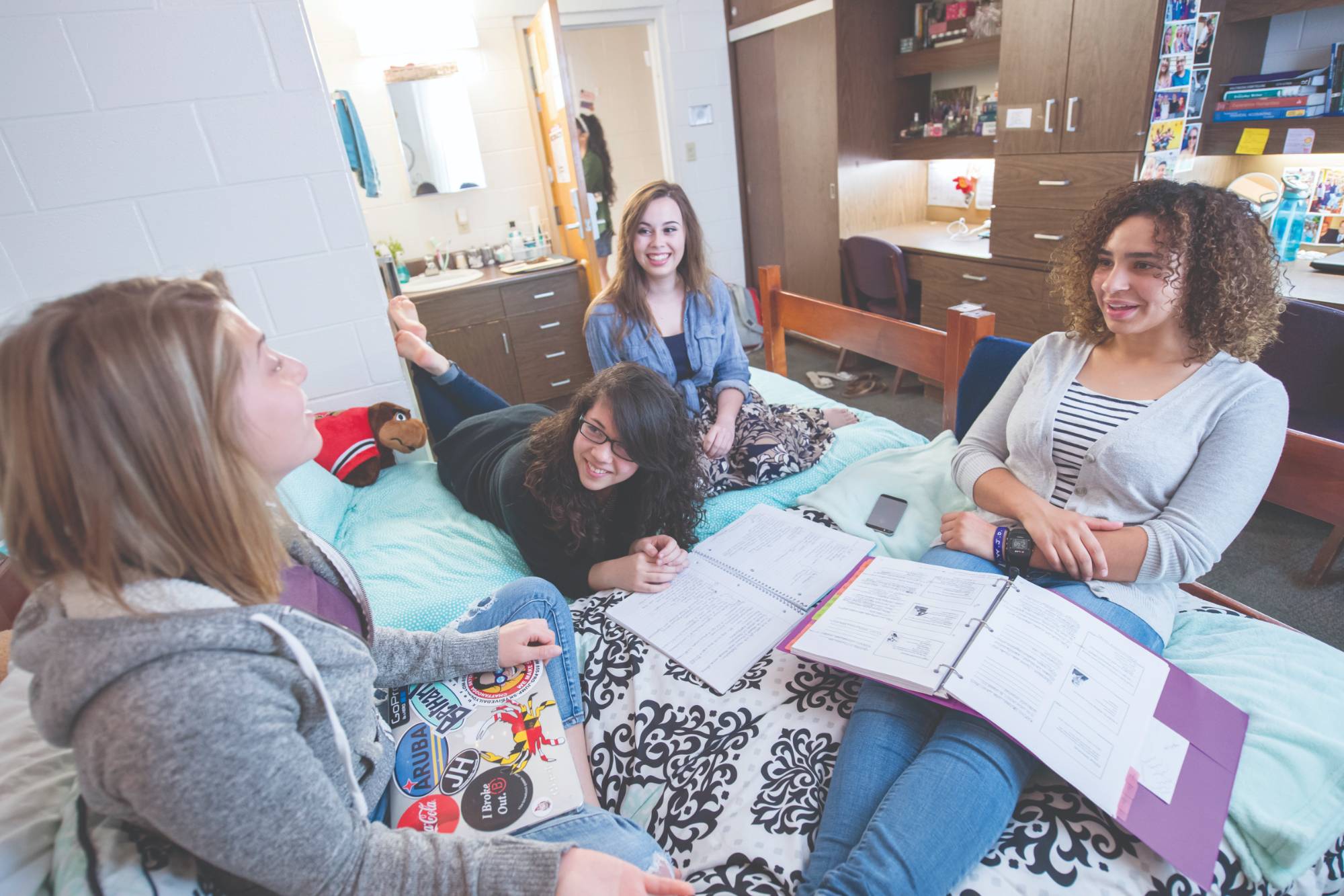 girls sitting on a bed